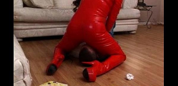  femdom in full red latex catsuit facesitting a poor guy